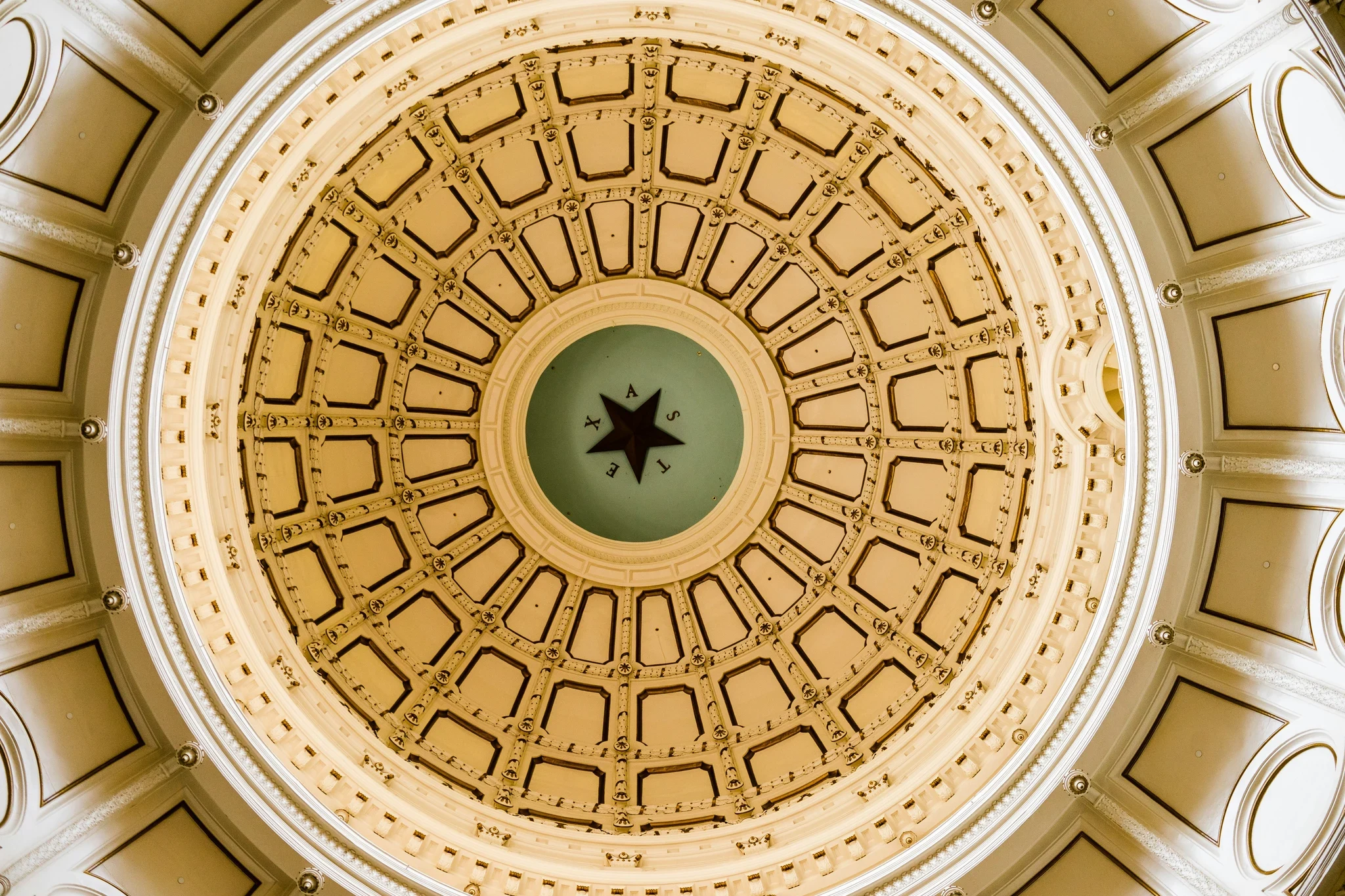 Looking up into the Texas State Capitol rotunda dome, with the Texas star at the center surrounded by radial gold-paneled coffering
